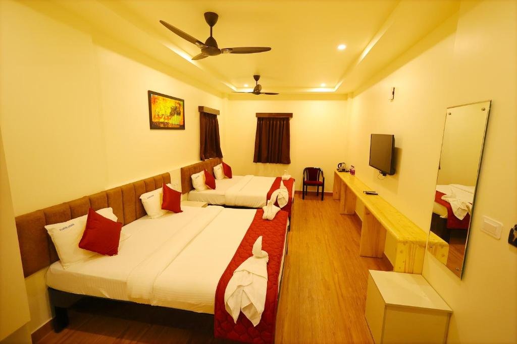 Spacious and clean guest room at Hotel Vijaya Grand Srikalahasti featuring air conditioning, flat-screen TV, and comfortable double bed.