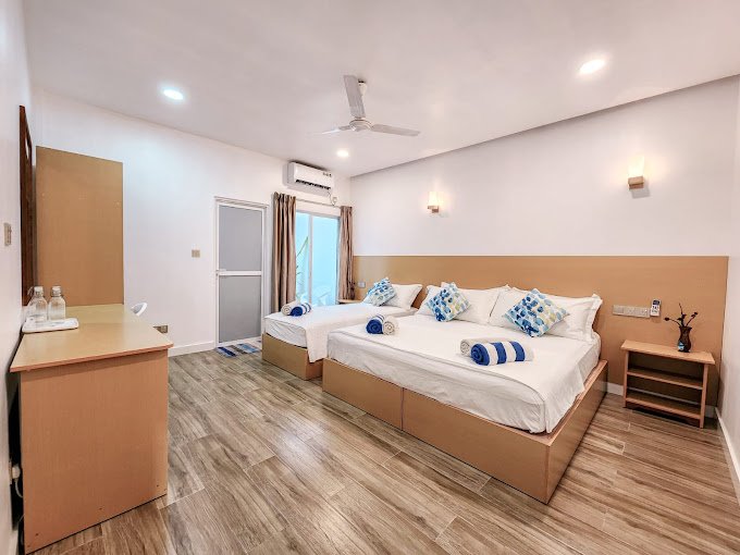 right and comfortable guest room at Raalhu Fonu Maldives with cozy bed and tropical decor