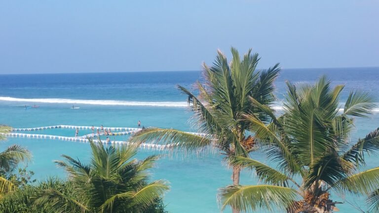 Relaxing swimming pool at Hathaa Beach Maldives surrounded by loungers and tropical scenery