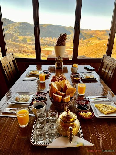 Family enjoying Moroccan cuisine on the terrace of Rise In Valley hotel, Ifrane.