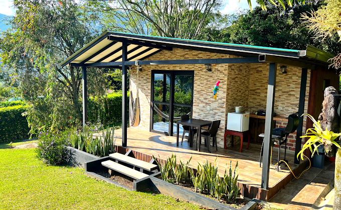 Exterior view of Chalets Villa Marina surrounded by green mountains in Copacabana, Colombia