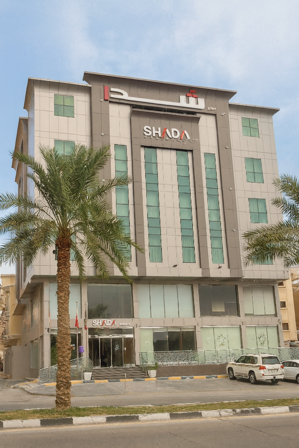 A modern mid-rise hotel building at dusk, with warm exterior lighting, large windows, and surrounding greenery.”