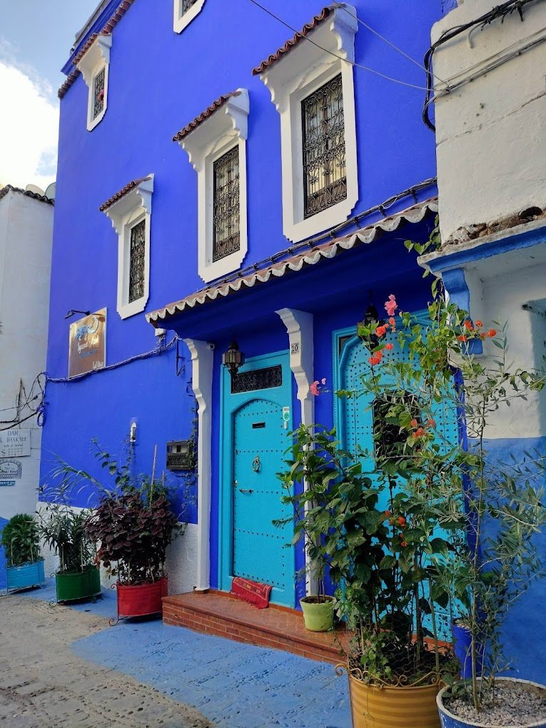 Exterior view of Iguana Azul boutique hotel in the blue medina of Chefchaouen, Morocco, showing traditional architecture and blue-washed walls