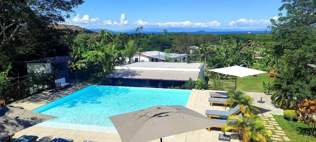 Exterior view of Nosy Be Sun Hôtel surrounded by tropical vegetation in Nosy Be, Madagascar