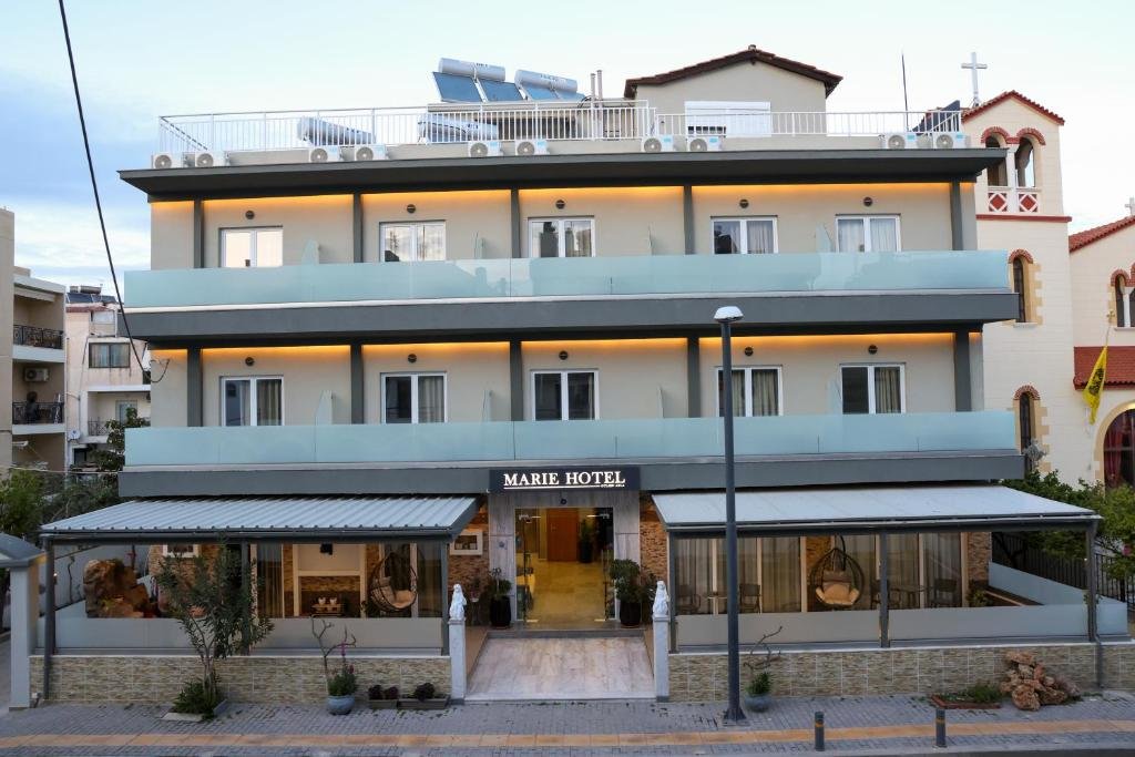 Exterior of Marie Hotel in Kos Town, Greece, with welcoming entrance and Mediterranean flowers