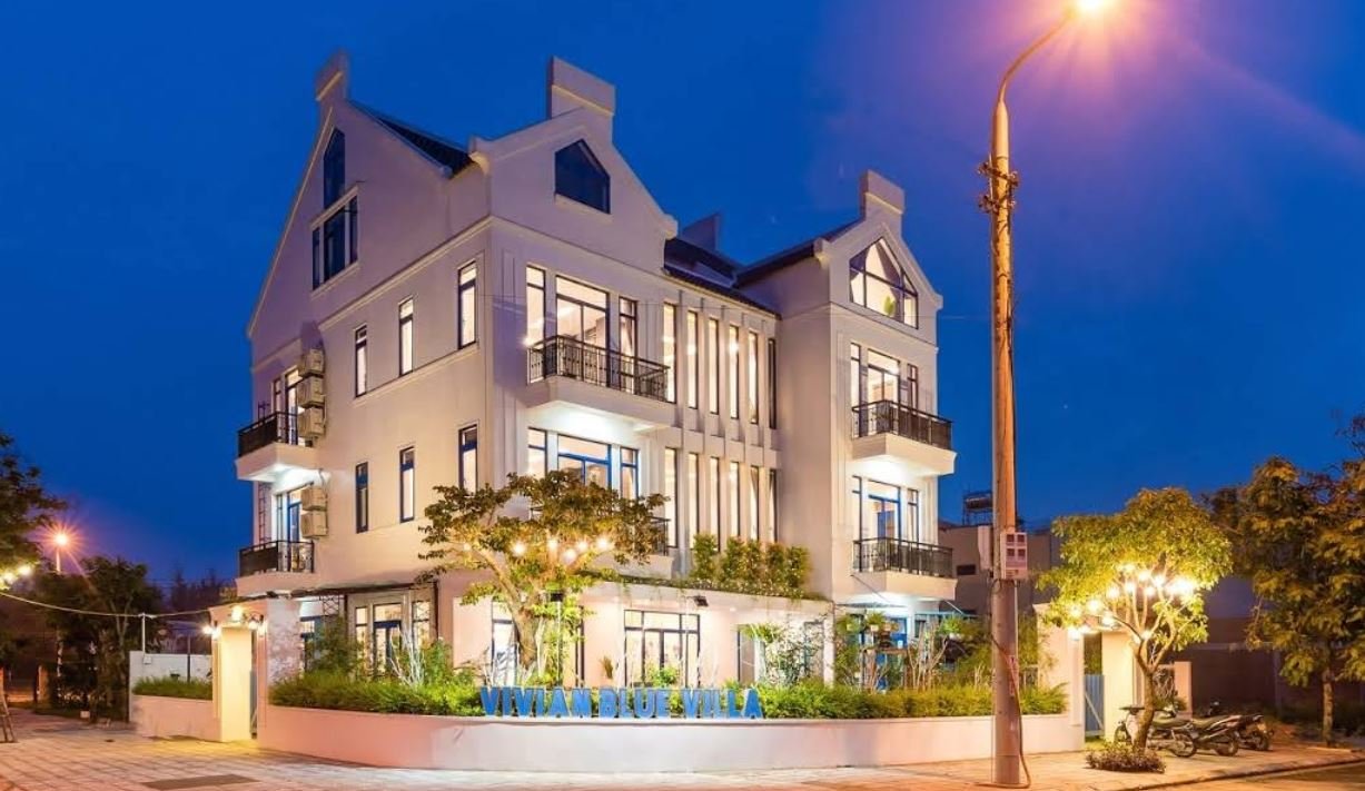 Blue Boutique Villa Hoi An riverside exterior surrounded by tropical greenery in An Bang Vietnam