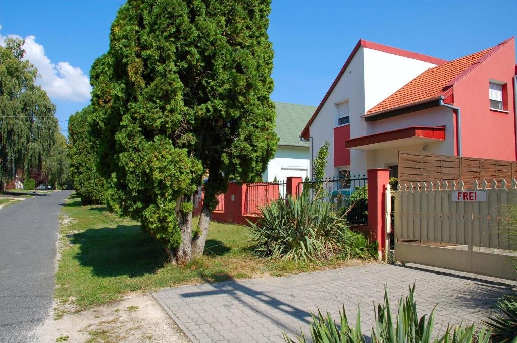 Exterior view of Laci Apartman in Zalakaros, Hungary on a quiet tree-lined street