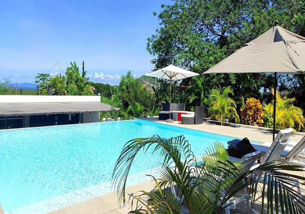 Swimming pool at Nosy Be Sun Hôtel surrounded by tropical greenery in Nosy Be, Madagascar