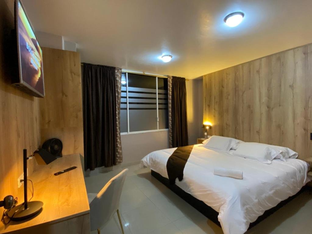 Clean and comfortable guest room at Hotel Wampushkar in Zamora, Ecuador
