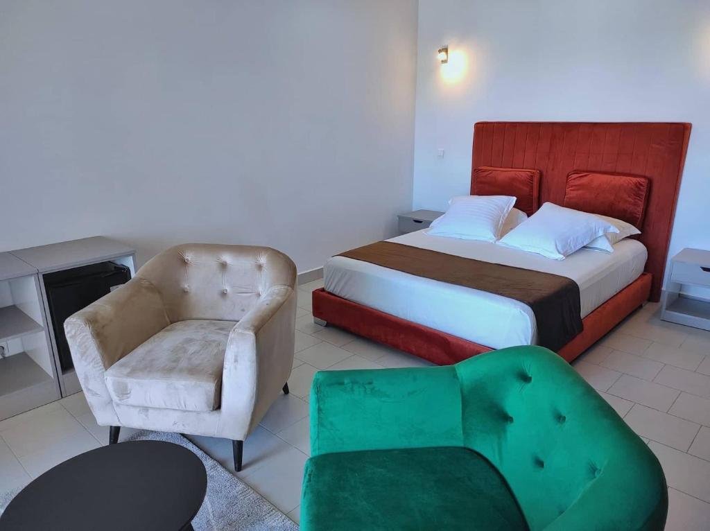 Bedroom at Nosy Be Sun Hôtel featuring natural light and simple island comfort