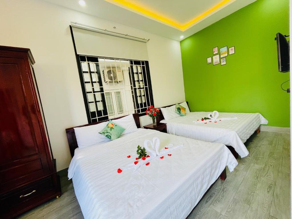 Comfortable guest room at Full House Homestay with bed, desk, and natural light