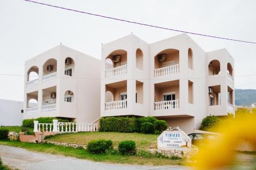 Exterior of Finikas Apartments surrounded by olive trees in Plakias Greece