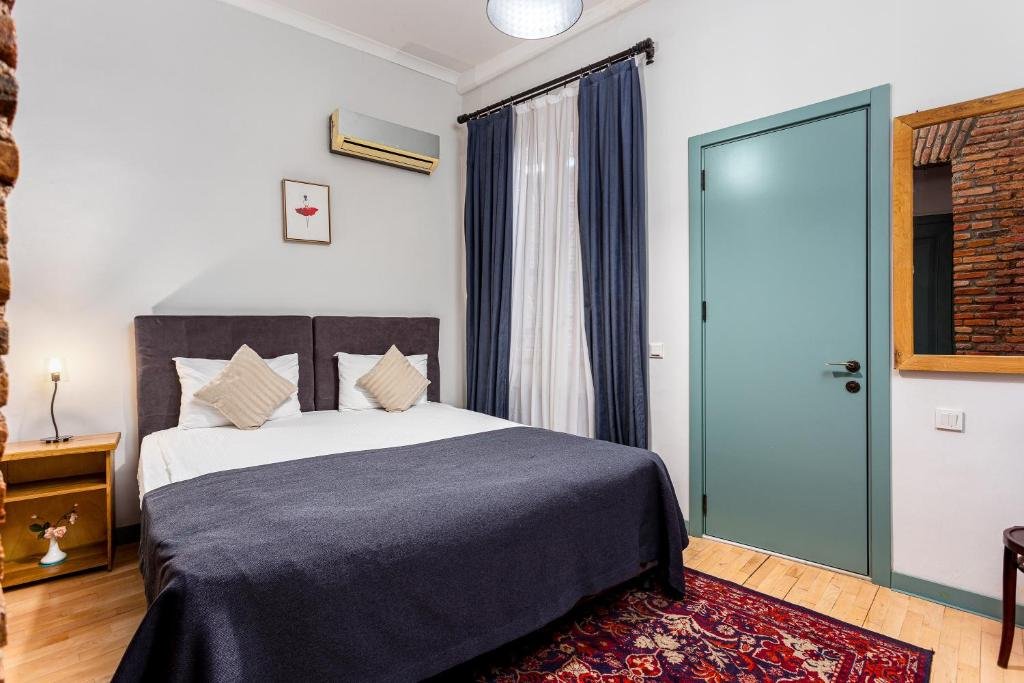 Traditional-style guest room at Ethnograph Hotel Old Tbilisi with wooden decor and cozy atmosphere