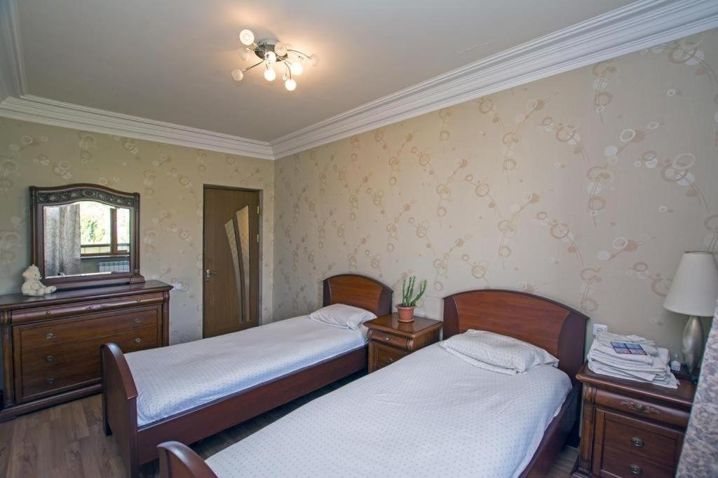 Comfortable bedroom at LeSi Apartament in Yerevan, Armenia, with fresh linens, a large bed, and city view from the window.