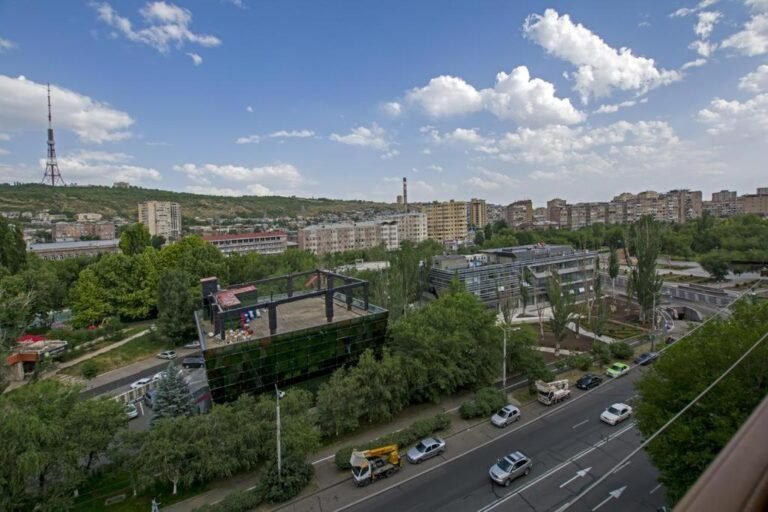 Exterior view of LeSi Apartament building in central Yerevan, Armenia, showing modern architecture and street access.
